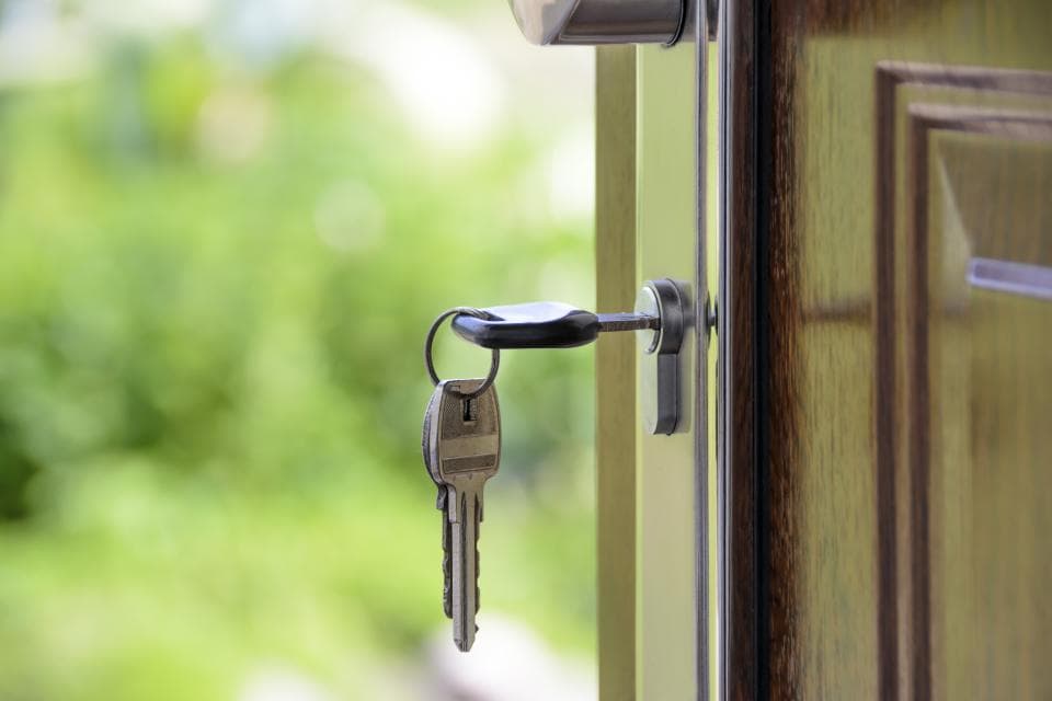 A set of keys left in an open front door