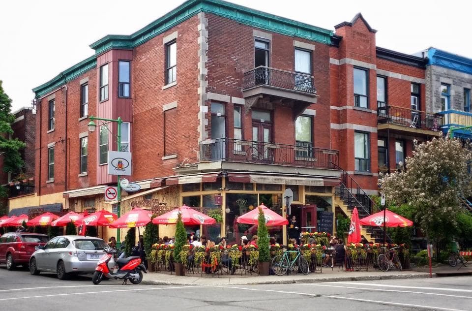 A three-storey brick apartment building on a city corner