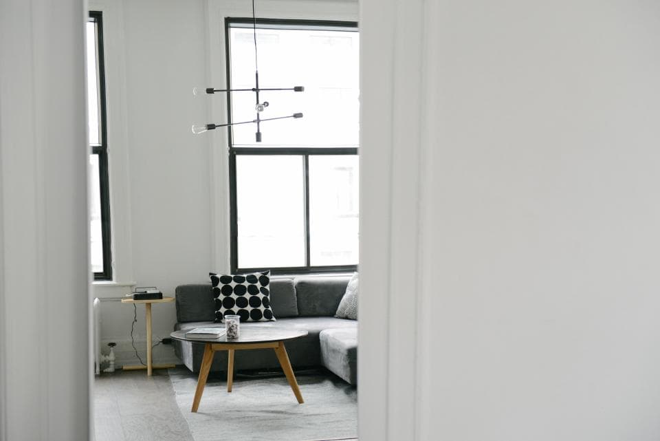 Bright living room with a grey sofa and a large window
